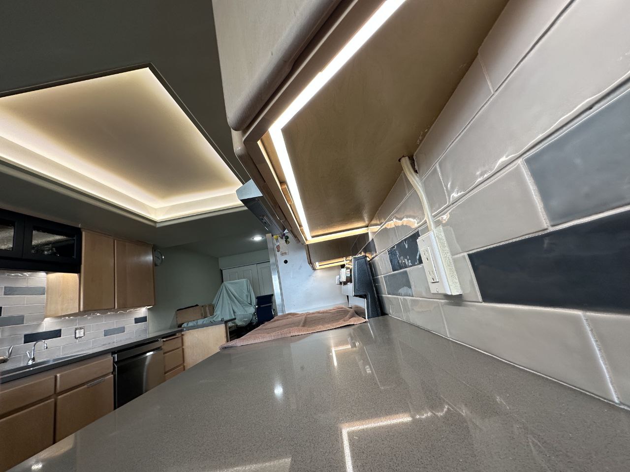 Kitchen glass-brick backsplash with under-cabinet lighting and receptacles